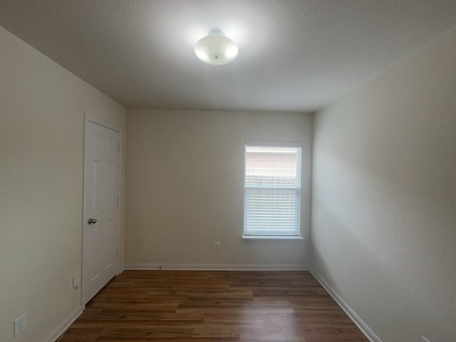 10009 Iron Ridge Dr, Fort Worth, TX 76140 - spare room featuring wood finished floors and baseboards