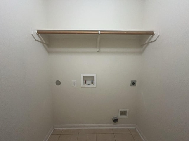 10009 Iron Ridge Dr, Fort Worth, TX 76140 - laundry area with hookup for an electric dryer, washer hookup, baseboards, light tile patterned floors, and hookup for a gas dryer