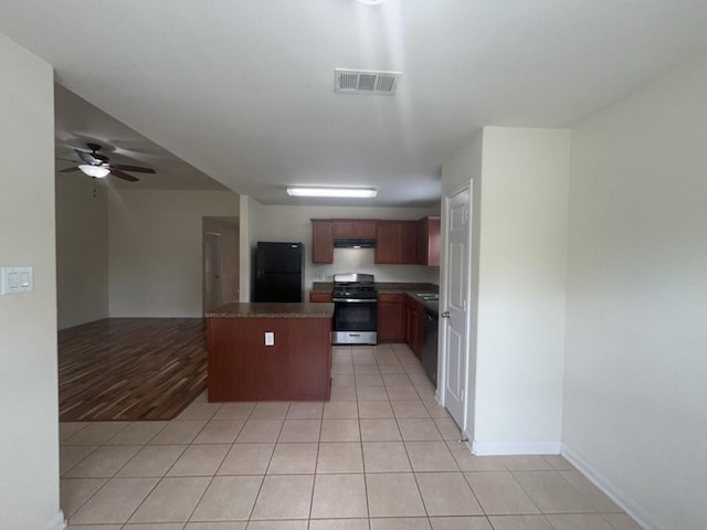 10009 Iron Ridge Dr, Fort Worth, TX 76140 - kitchen featuring stainless steel appliances, open floor plan, a center island, under cabinet range hood, and ceiling fan