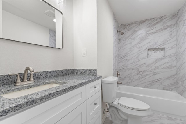 bathroom with marble finish floors, toilet, tub / shower combination, and vanity