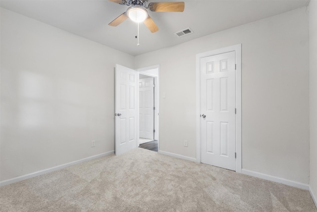unfurnished bedroom featuring carpet flooring, baseboards, and a ceiling fan