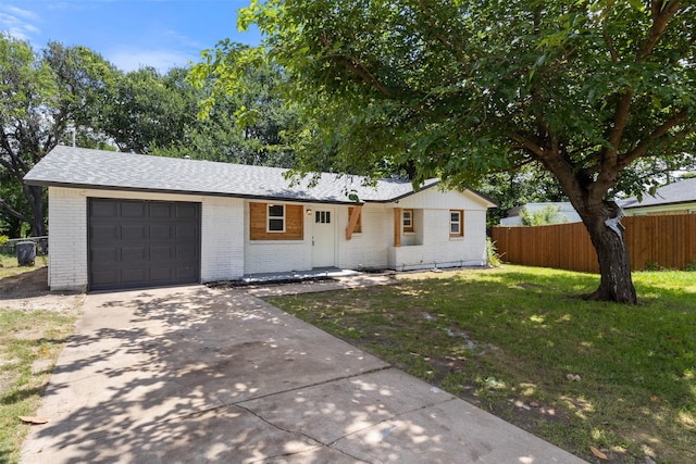 single story home with brick siding, a garage, driveway, and a shingled roof