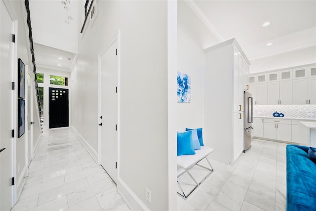 hall with light marble finish flooring, recessed lighting, and baseboards