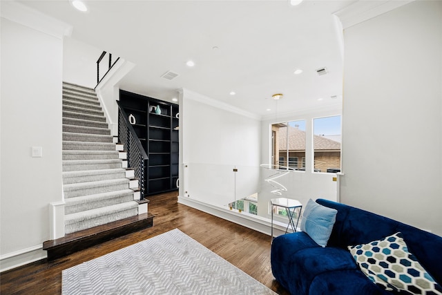 sitting room with crown molding, wood finished floors, stairs, recessed lighting, and baseboards