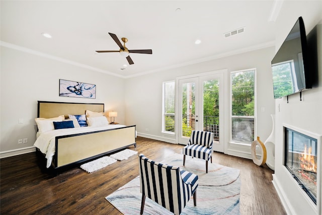 bedroom with access to outside, wood finished floors, french doors, ornamental molding, and baseboards