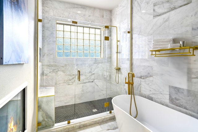 bathroom featuring a freestanding bath and a shower stall