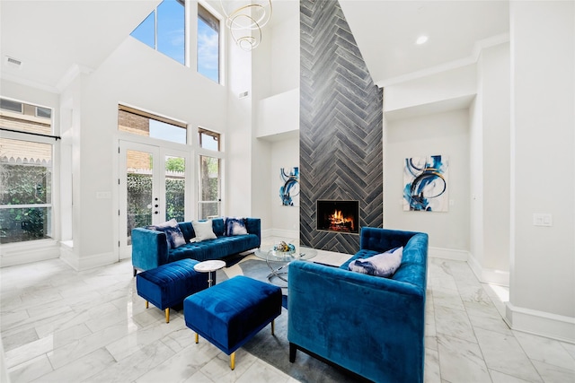 living area with light marble finish floors, a tiled fireplace, baseboards, a towering ceiling, and french doors