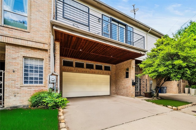 view of front facade with a garage, concrete driveway, and brick siding