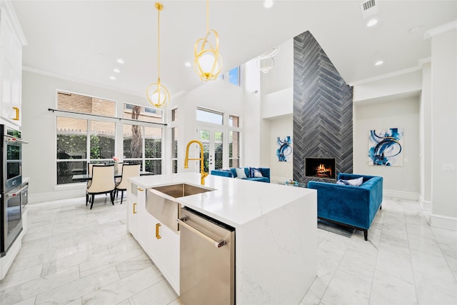 kitchen with light marble finish flooring, a sink, dishwasher, white cabinetry, and recessed lighting