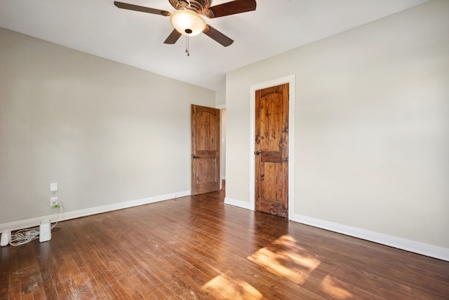 empty room featuring ceiling fan, wood finished floors, and baseboards