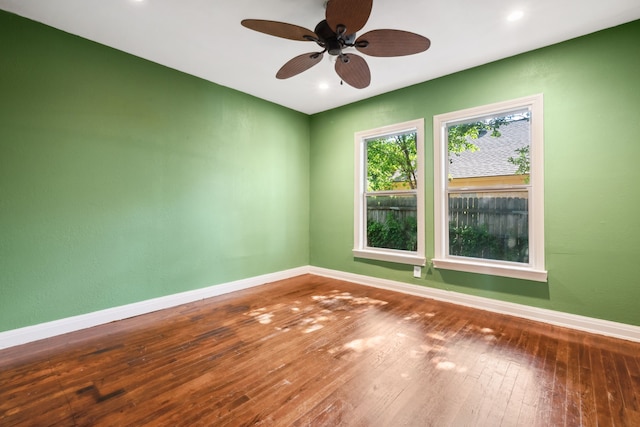 spare room with baseboards, a ceiling fan, wood-type flooring, and recessed lighting