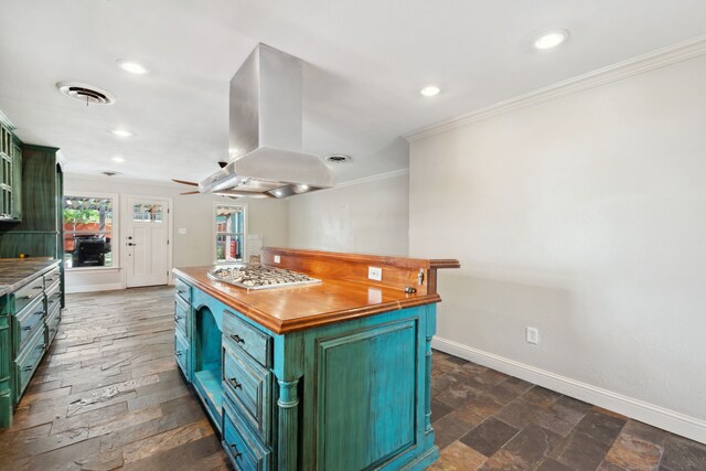 kitchen with green cabinetry, crown molding, baseboards, recessed lighting, and island exhaust hood