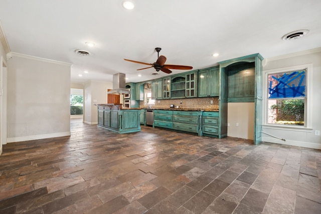 kitchen with green cabinets, crown molding, stainless steel dishwasher, extractor fan, and baseboards