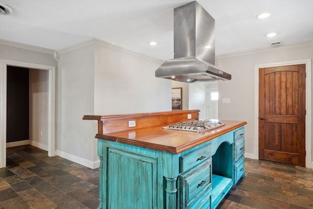 kitchen with blue cabinets, stainless steel gas cooktop, island exhaust hood, crown molding, and stone tile flooring