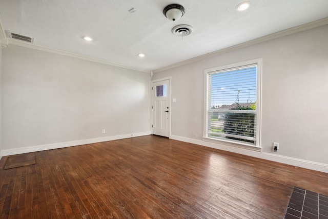 empty room featuring crown molding, baseboards, wood-type flooring, and recessed lighting