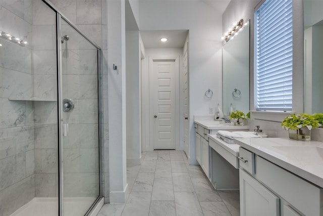 full bath with marble look tiles, a stall shower, double vanity, and recessed lighting