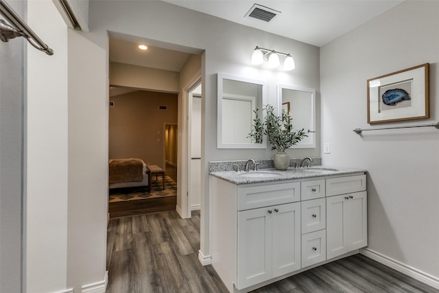 2701 W Prairie Creek Dr, Richardson, TX 75080 - full bathroom with wood finished floors, ensuite bath, double vanity, and baseboards