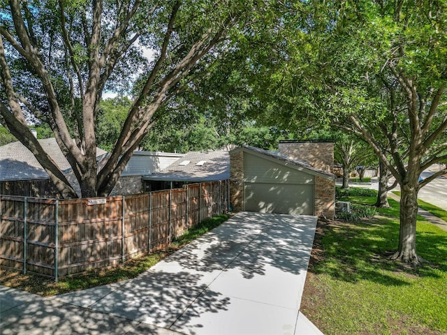 2701 W Prairie Creek Dr, Richardson, TX 75080 - view of front of house with concrete driveway, a garage, and a chimney