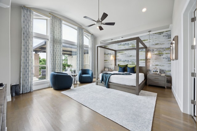 bedroom with multiple windows, wood finished floors, lofted ceiling, recessed lighting, and a ceiling fan
