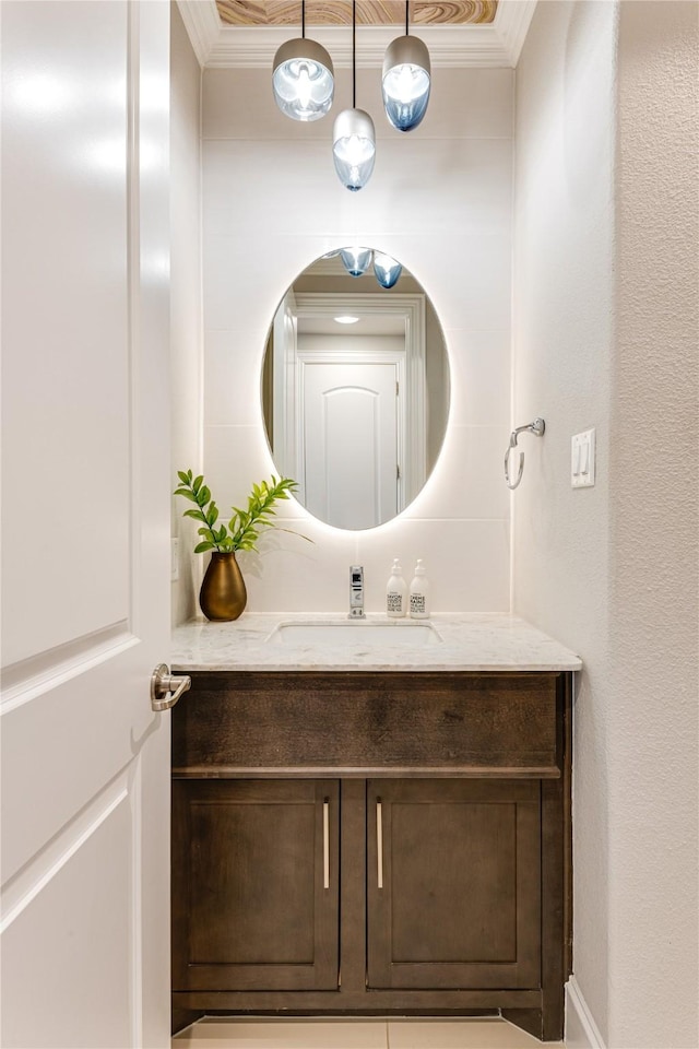 bathroom with ornamental molding and vanity
