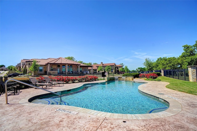 community pool featuring fence and a patio