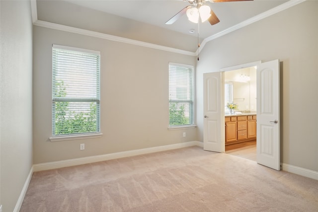 unfurnished bedroom featuring light colored carpet, baseboards, ornamental molding, connected bathroom, and ceiling fan