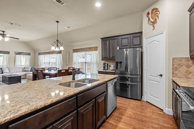 2026 Bay Laurel Dr, Weatherford, TX 76086 - kitchen featuring appliances with stainless steel finishes, vaulted ceiling, decorative backsplash, ceiling fan, and light wood-type flooring