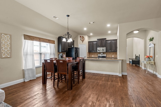 2026 Bay Laurel Dr, Weatherford, TX 76086 - dining room with arched walkways, dark wood-style floors, a chandelier, baseboards, and recessed lighting