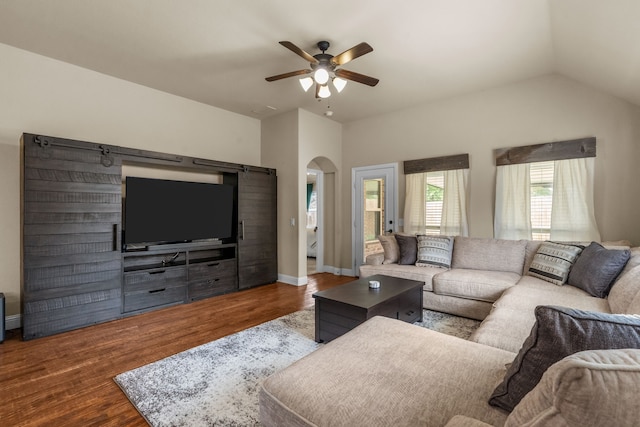 2026 Bay Laurel Dr, Weatherford, TX 76086 - living room featuring a ceiling fan, arched walkways, wood finished floors, lofted ceiling, and a barn door