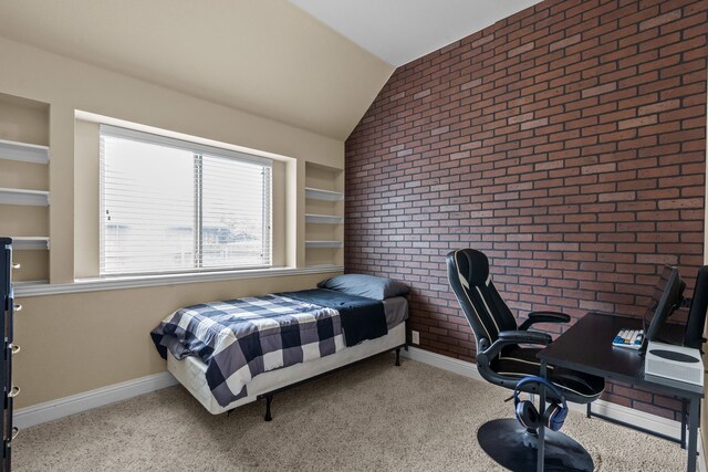 2026 Bay Laurel Dr, Weatherford, TX 76086 - bedroom featuring vaulted ceiling, brick wall, carpet, and an office area