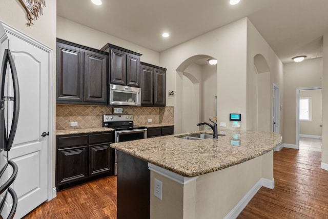 2026 Bay Laurel Dr, Weatherford, TX 76086 - kitchen with stainless steel appliances, a sink, light stone countertops, backsplash, and dark wood finished floors