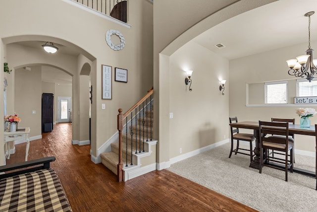 2026 Bay Laurel Dr, Weatherford, TX 76086 - dining space with a chandelier, wood finished floors, stairs, baseboards, and arched walkways
