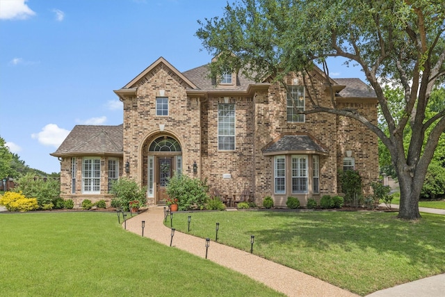 1209 Bel Air Dr, Allen, TX 75013 - traditional home featuring brick siding, a front yard, and roof with shingles