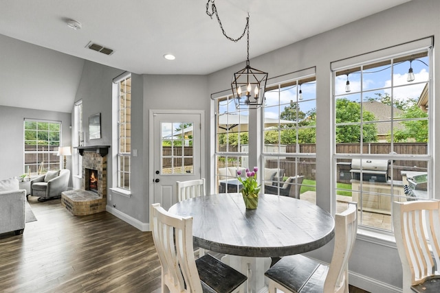 1209 Bel Air Dr, Allen, TX 75013 - dining room with a brick fireplace, baseboards, a chandelier, dark wood finished floors, and recessed lighting