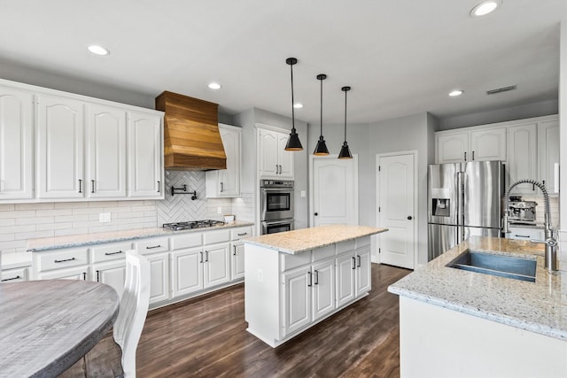 1209 Bel Air Dr, Allen, TX 75013 - kitchen with stainless steel appliances, a sink, custom exhaust hood, a kitchen island, and recessed lighting