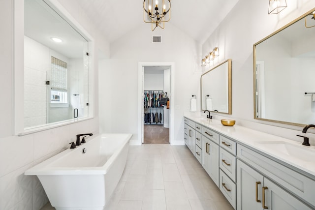 4141 Splitrock Dr, Prosper, TX 75078 - bathroom with a shower stall, a freestanding bath, vaulted ceiling, double vanity, and a chandelier