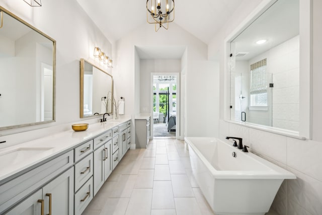 4141 Splitrock Dr, Prosper, TX 75078 - full bath featuring a freestanding bath, lofted ceiling, a stall shower, double vanity, and tile patterned floors