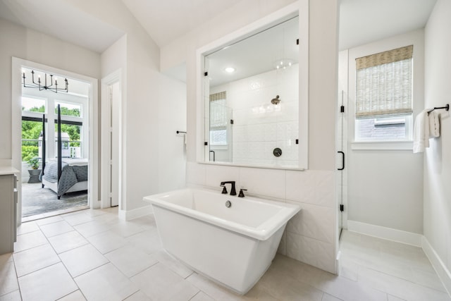 4141 Splitrock Dr, Prosper, TX 75078 - bathroom featuring a stall shower, baseboards, tile patterned flooring, and a freestanding bath