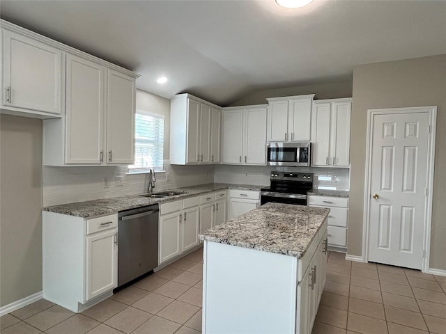 3108 Bryce Dr, Wylie, TX 75098 - kitchen featuring stainless steel appliances, light tile patterned flooring, vaulted ceiling, tasteful backsplash, and white cabinetry
