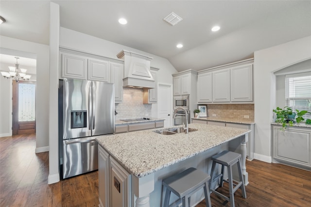 432 Sagebrush Dr, Aledo, TX 76008 - kitchen featuring appliances with stainless steel finishes, a sink, premium range hood, dark wood-type flooring, and lofted ceiling