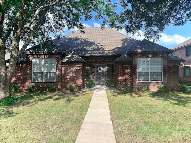 425 N Gaston Dr, Wylie, TX 75098 - view of front facade featuring roof with shingles, brick siding, and a front lawn