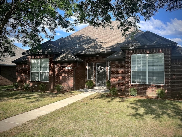 425 N Gaston Dr, Wylie, TX 75098 - view of front of property featuring brick siding, a front lawn, a shingled roof, and a chimney