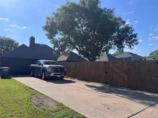 425 N Gaston Dr, Wylie, TX 75098 - view of home's exterior with a garage, driveway, and a chimney