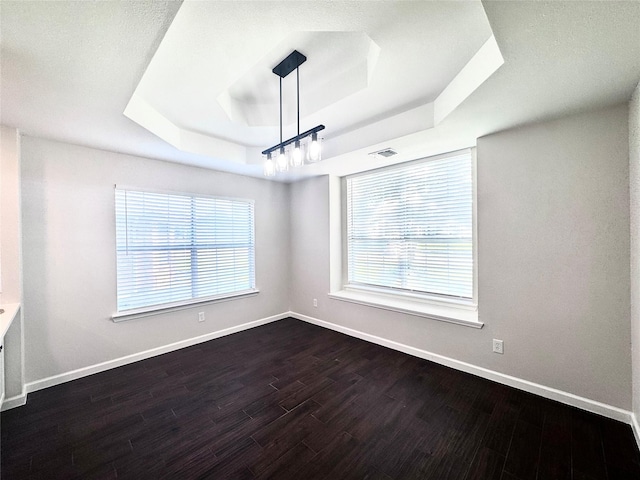 425 N Gaston Dr, Wylie, TX 75098 - unfurnished room with a raised ceiling, dark wood-style flooring, and baseboards