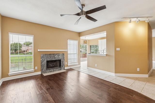 9434 Abbey Rd, Irving, TX 75063 - unfurnished living room with plenty of natural light, hardwood / wood-style flooring, and a ceiling fan
