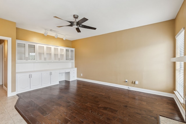 9434 Abbey Rd, Irving, TX 75063 - unfurnished living room with ceiling fan, track lighting, wood finished floors, and baseboards