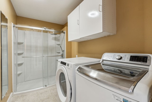 9434 Abbey Rd, Irving, TX 75063 - laundry room featuring washer and dryer, cabinet space, and light tile patterned floors