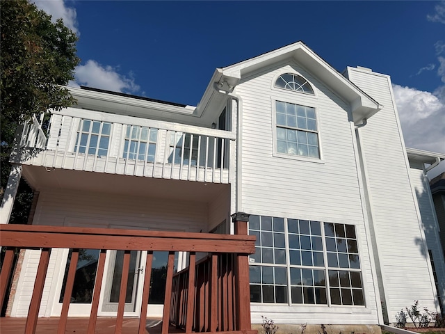9434 Abbey Rd, Irving, TX 75063 - rear view of property with a balcony and a chimney