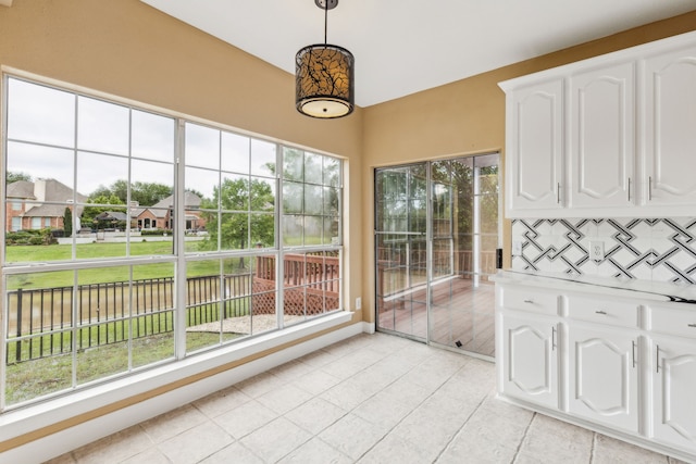 9434 Abbey Rd, Irving, TX 75063 - unfurnished sunroom featuring tile patterned floors and a water view
