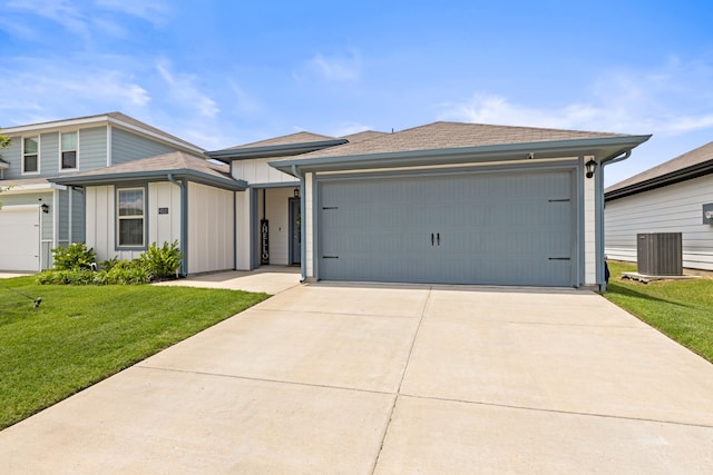 6512 Shoreline Ln, Princeton, TX 75407 - view of front of property featuring board and batten siding, a front lawn, central air condition unit, a garage, and driveway